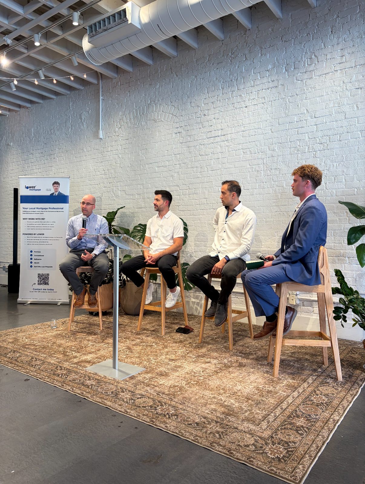 A four-person panel on stage at a RAL Meetup gathering